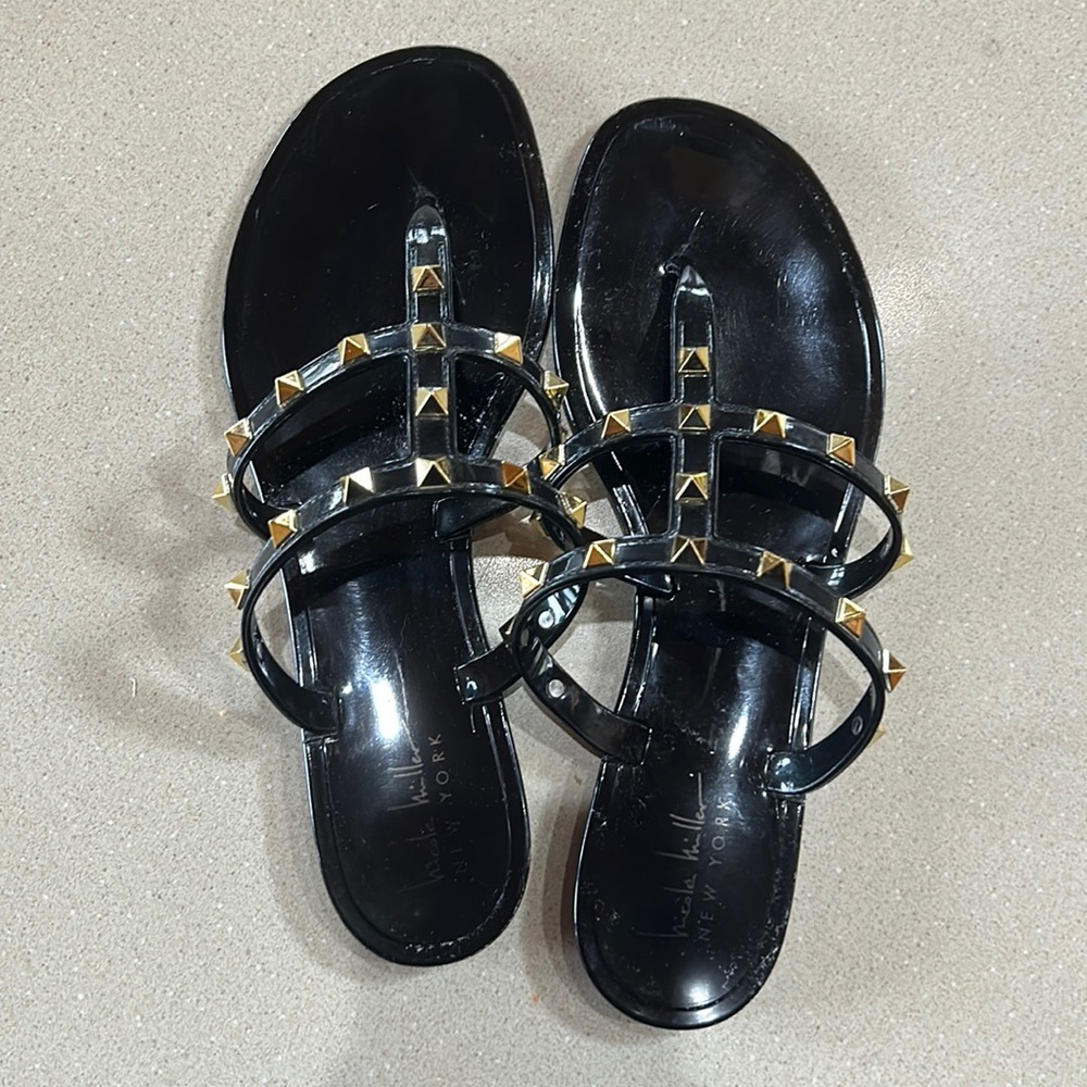 Black and gold studded flip flops